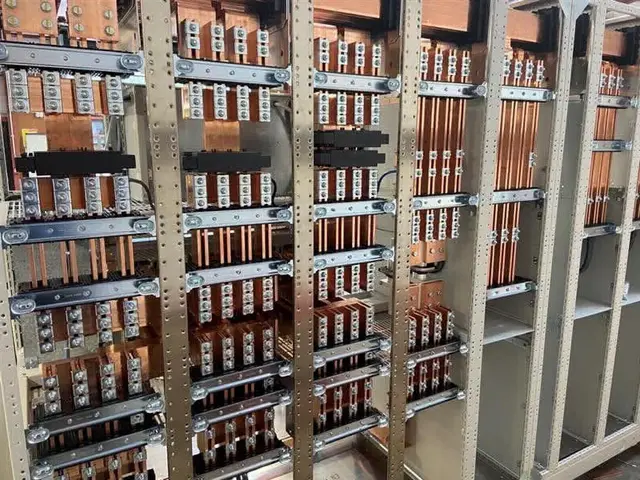 Copper busbar stock held on racking in the Beiene works
